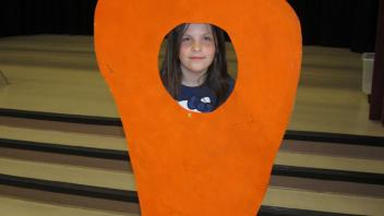 Child behind a carrot.