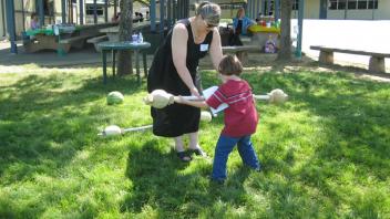 Students tested their strength using barbells with melons as weights