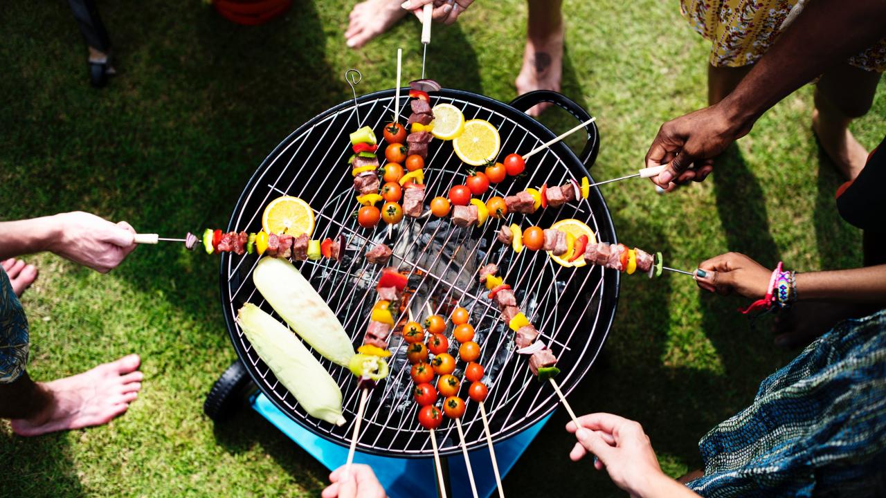 people grilling around a barbecue