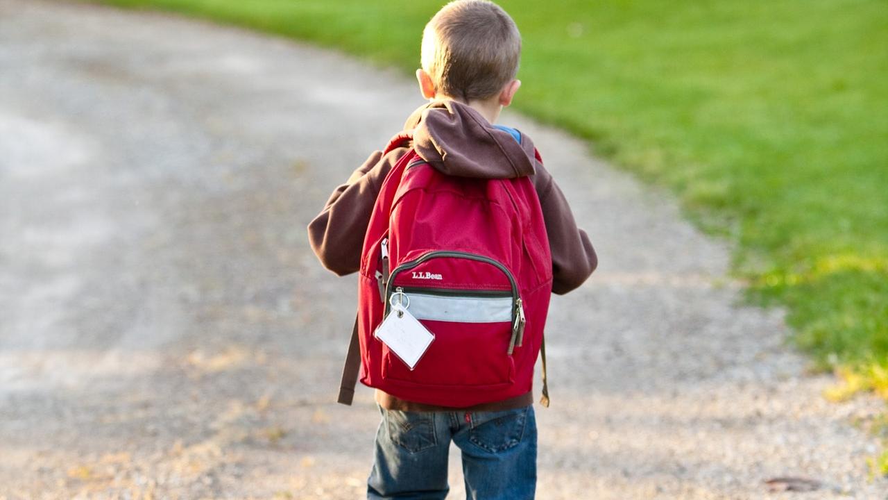 boy walking with backpack