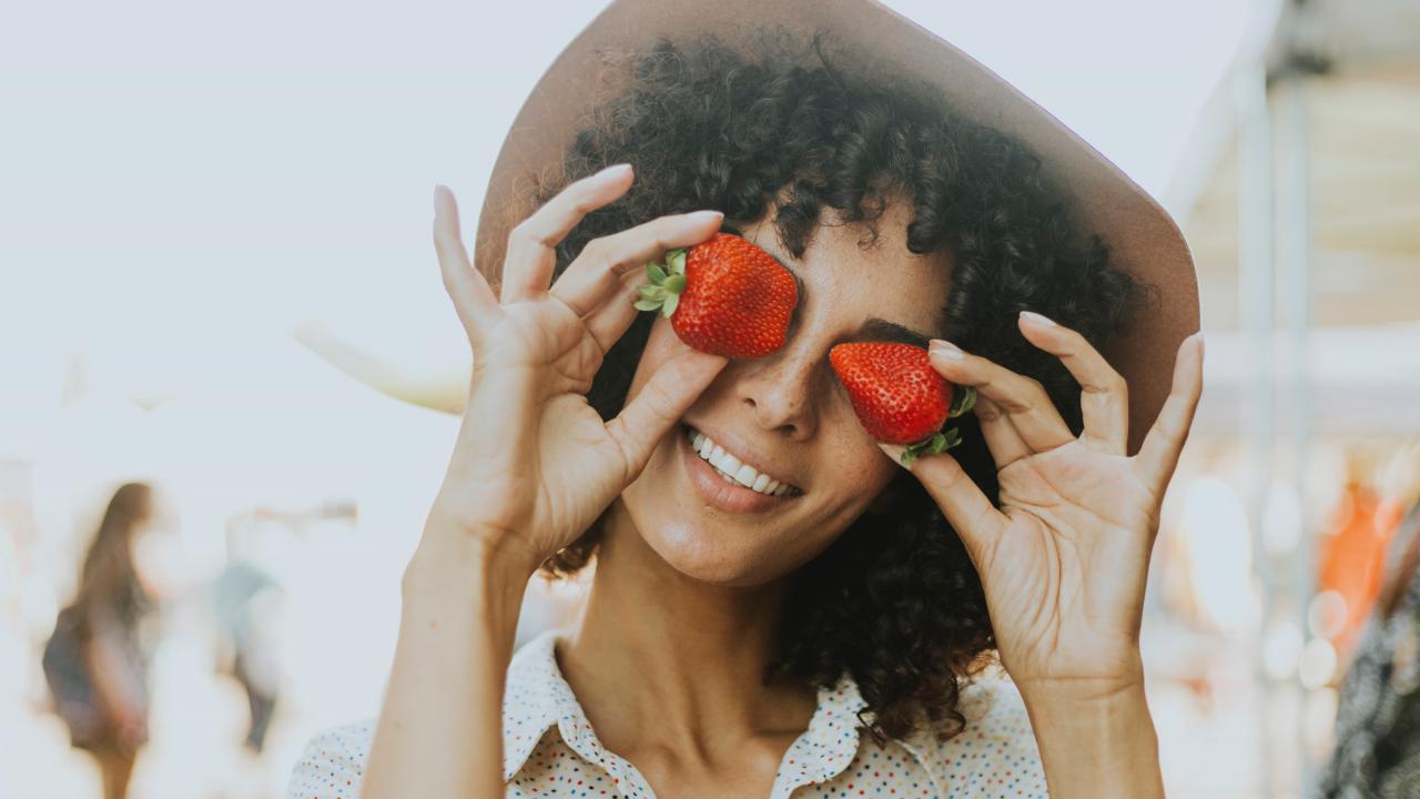 women holding strawberries