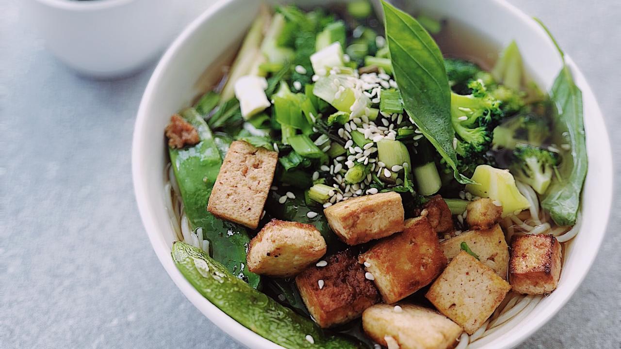 bowl of cooked tofu, greens, and rice