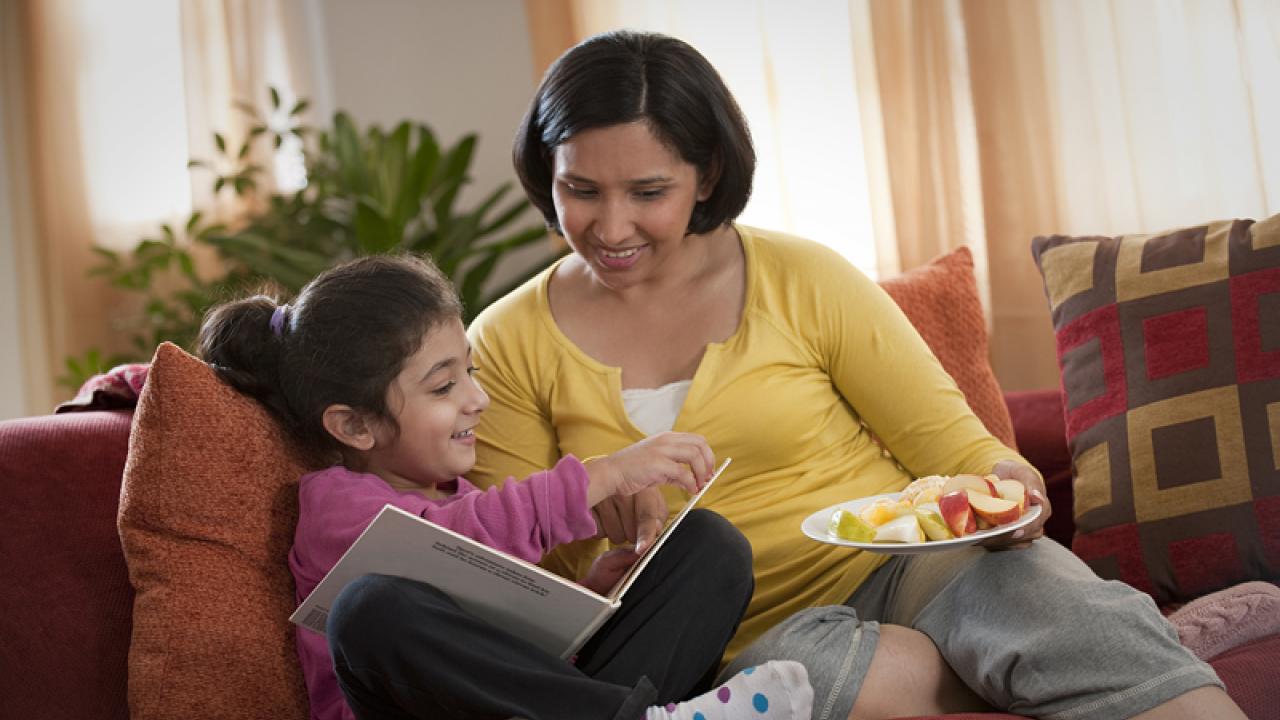 mother and daughter eating a snack