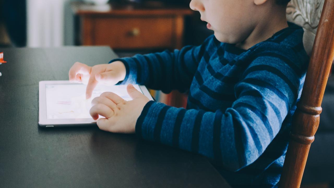 kid looking at a screen