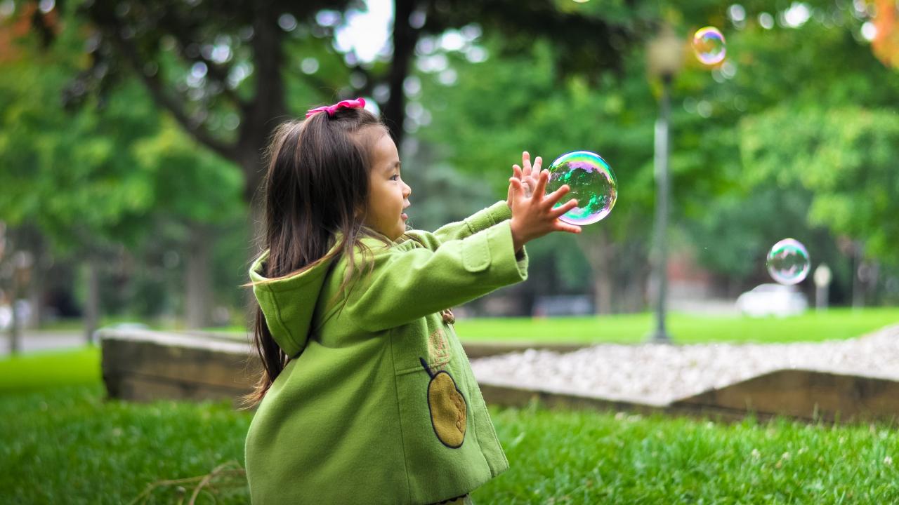 girl playing with bubbles