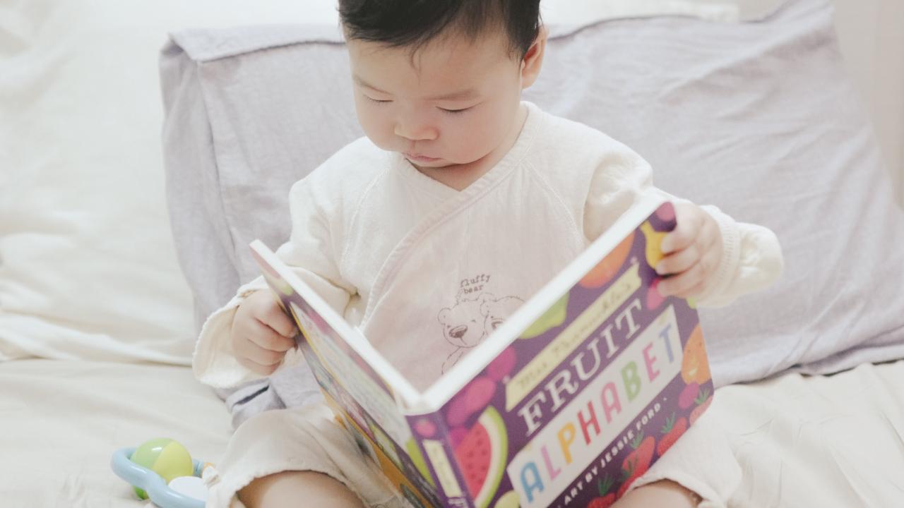 child reading a book about food