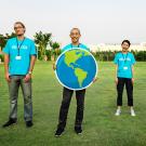 volunteers holding up an Earth poster