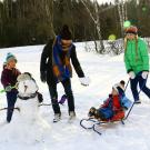 family playing in the snow