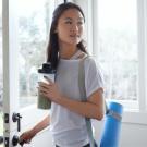 woman with yoga mat and health drink