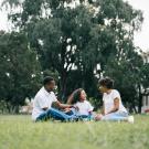 Family gathered around the grass outsided