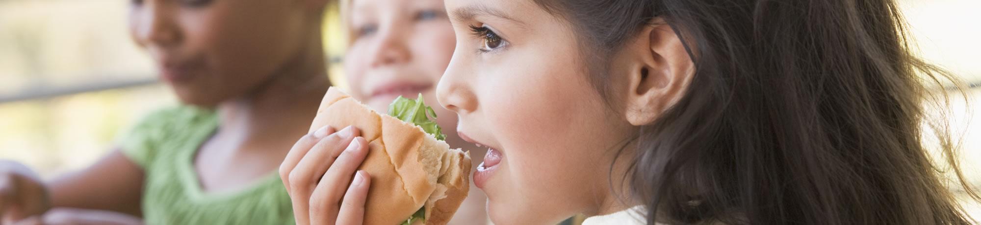 A girl eating a sandwhich.
